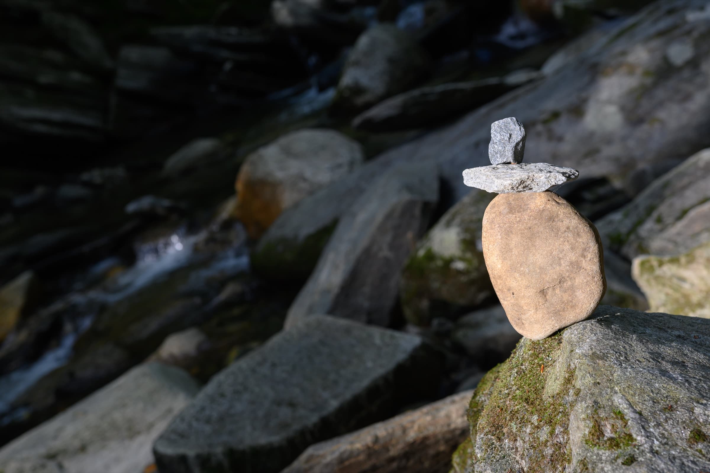 A small balanced stone stack on a boulder beside the stream near Hamilton Falls.